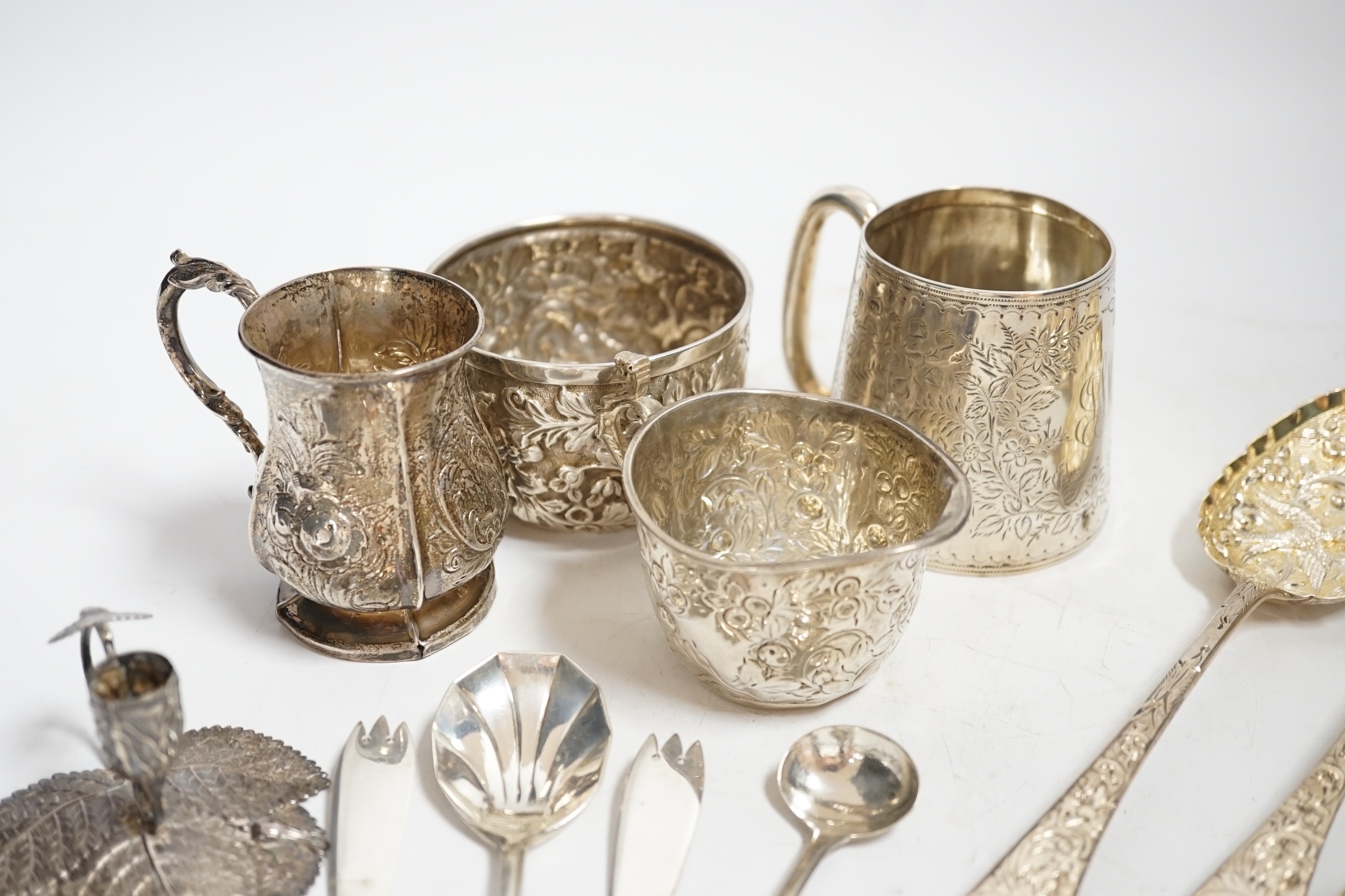 Two Victorian silver christening mugs, tallest 75mm, a Victorian silver cream jug and sugar bowl, a William IV silver leaf chamberstick by Taylor & Perry, Birmingham, 1830 and nine assorted items of silver flatware inclu